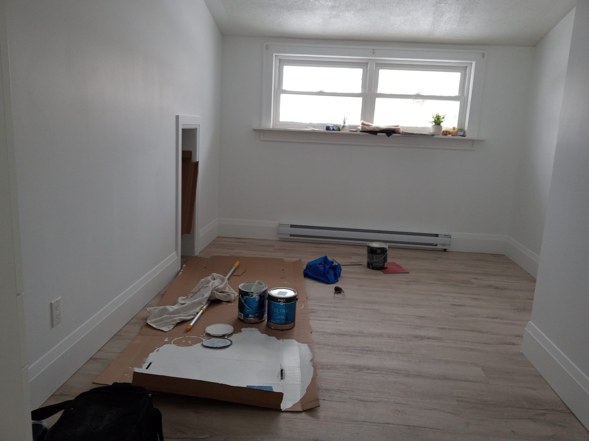 Interior room being painted with fresh white paint