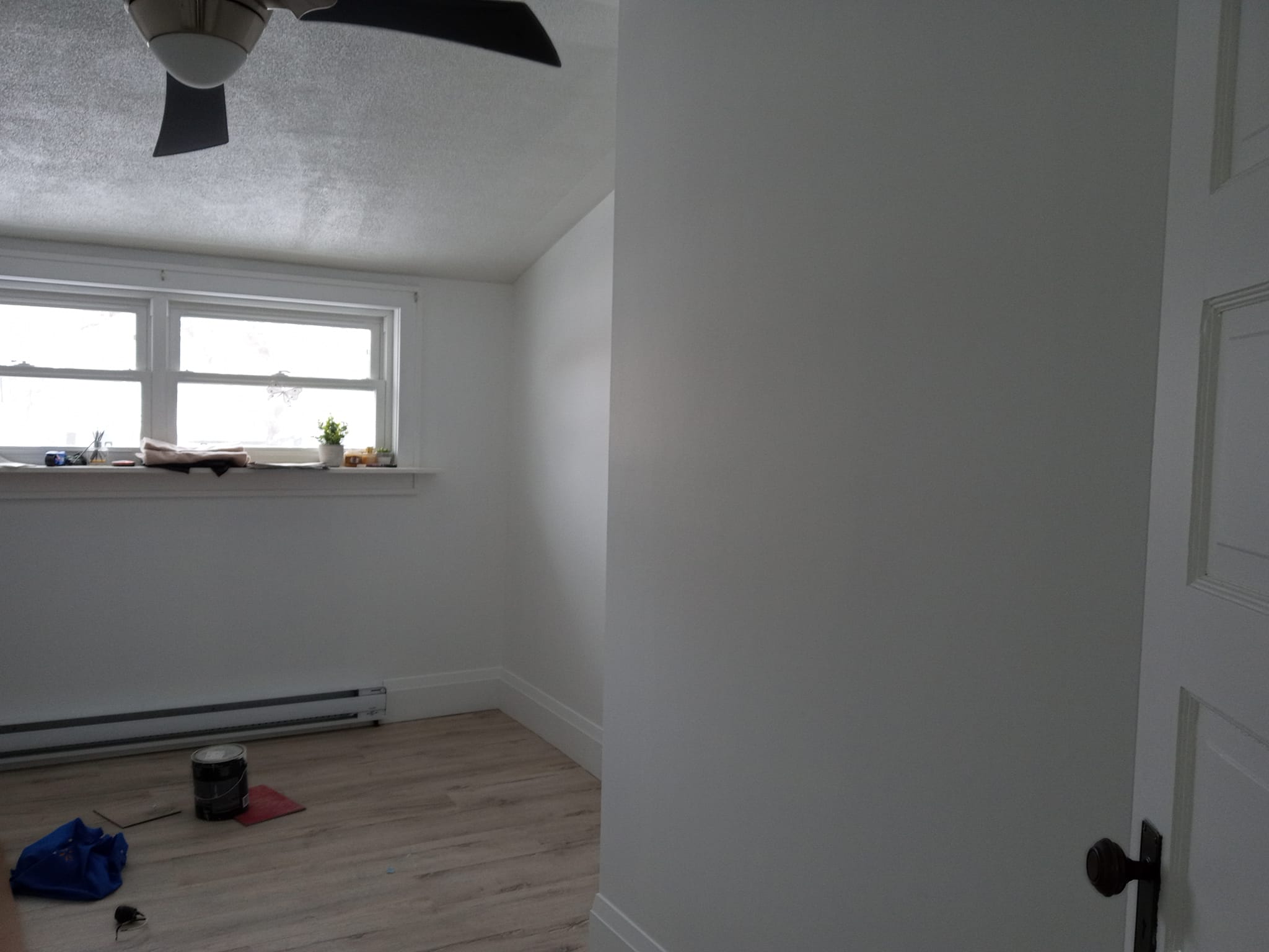 Painted room with new flooring and door hardware